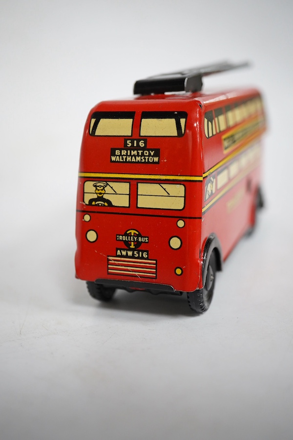 A boxed Wells Brimtoy tinplate clockwork trolley bus loosely in London Transport livery, together with three keys. Condition fair to good, clockwork motor appears to work correctly although has lost grip on the driving a